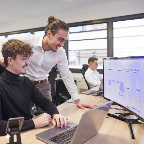 Developer teams working in the offices of the Dexon agency specialising in mobile and web application development