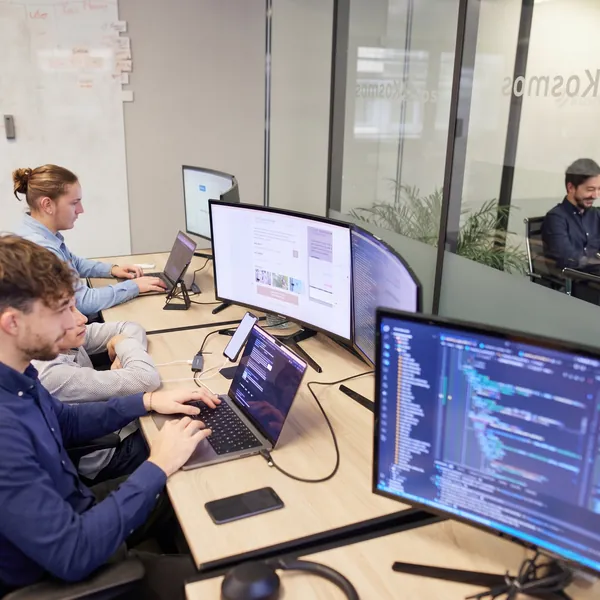Developer teams working in the offices of the Dexon agency specialising in mobile and web application development