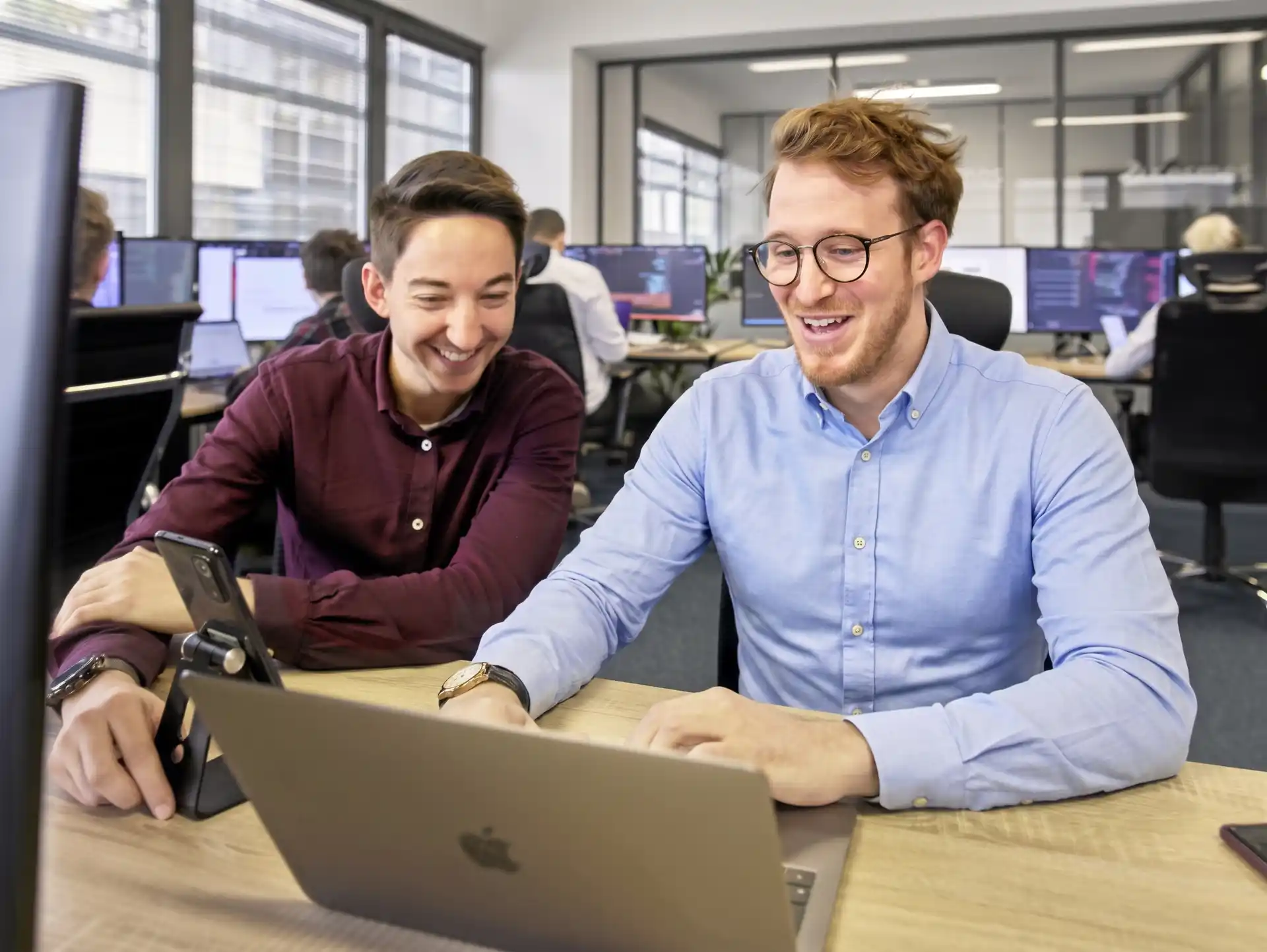 Developer teams working in the offices of the Dexon agency specialising in mobile and web application development